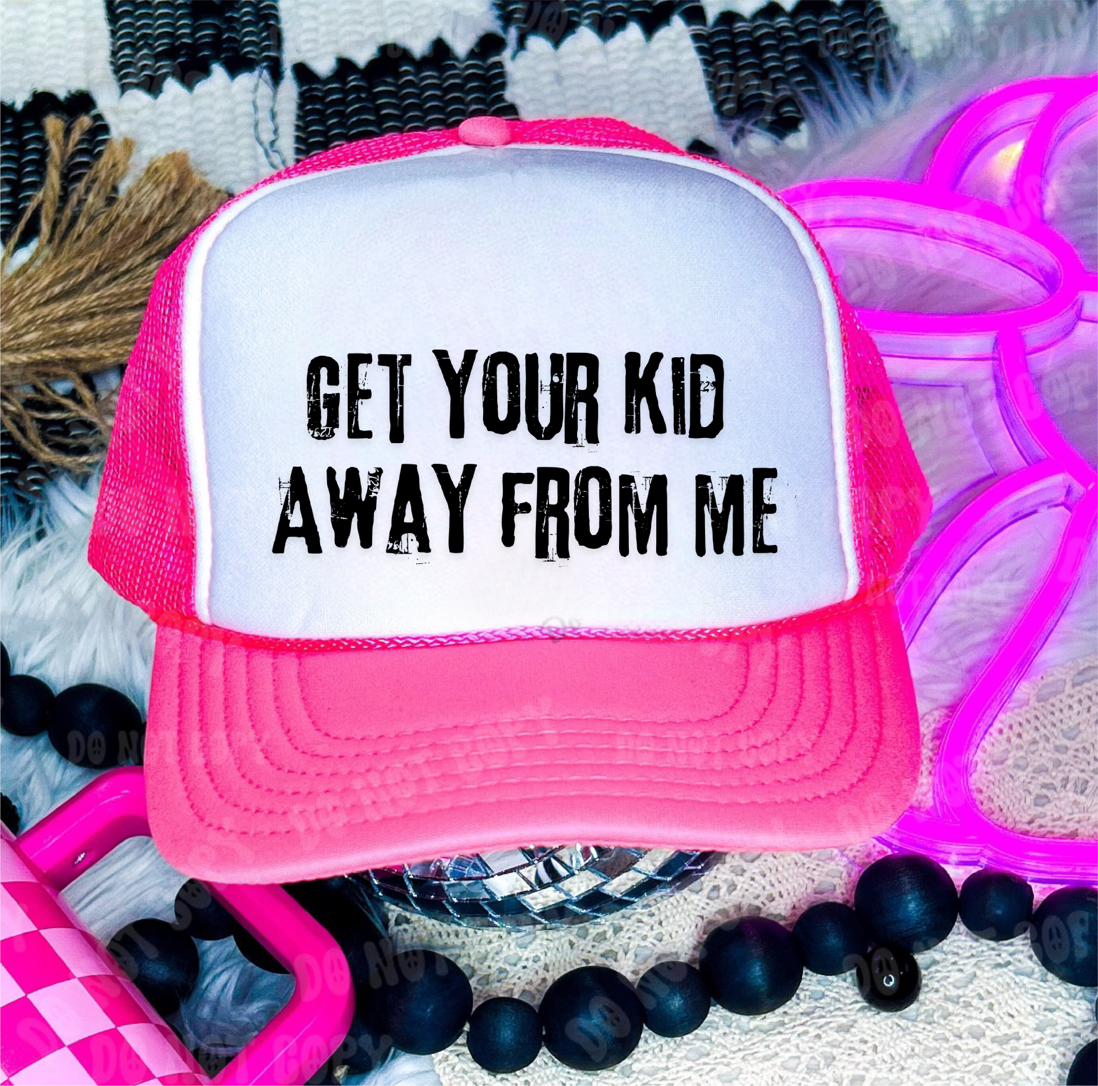 Pink and white cap with 'GET YOUR KID AWAY FROM ME' text on a patterned background