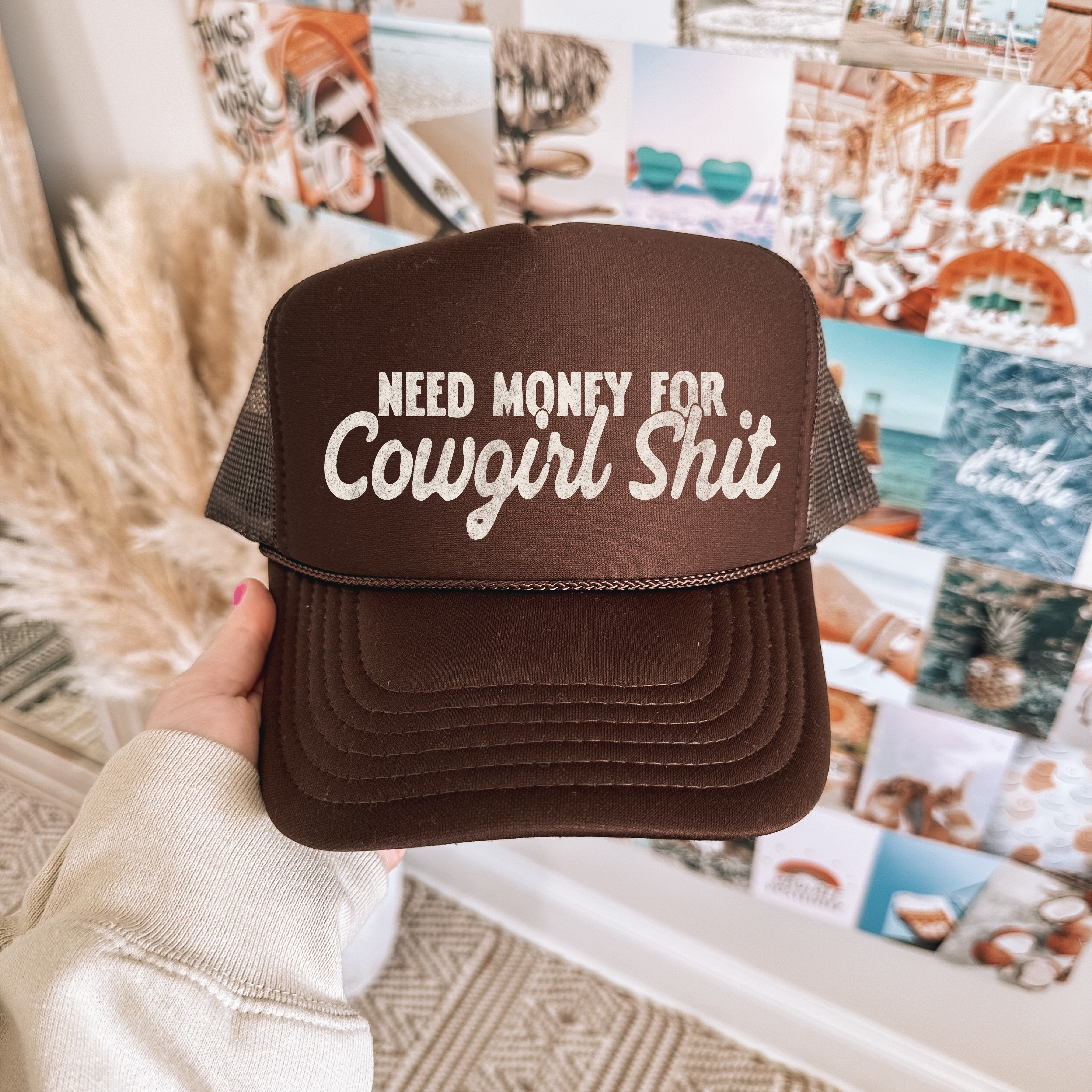 Brown cap with text held in front of a collage of photos