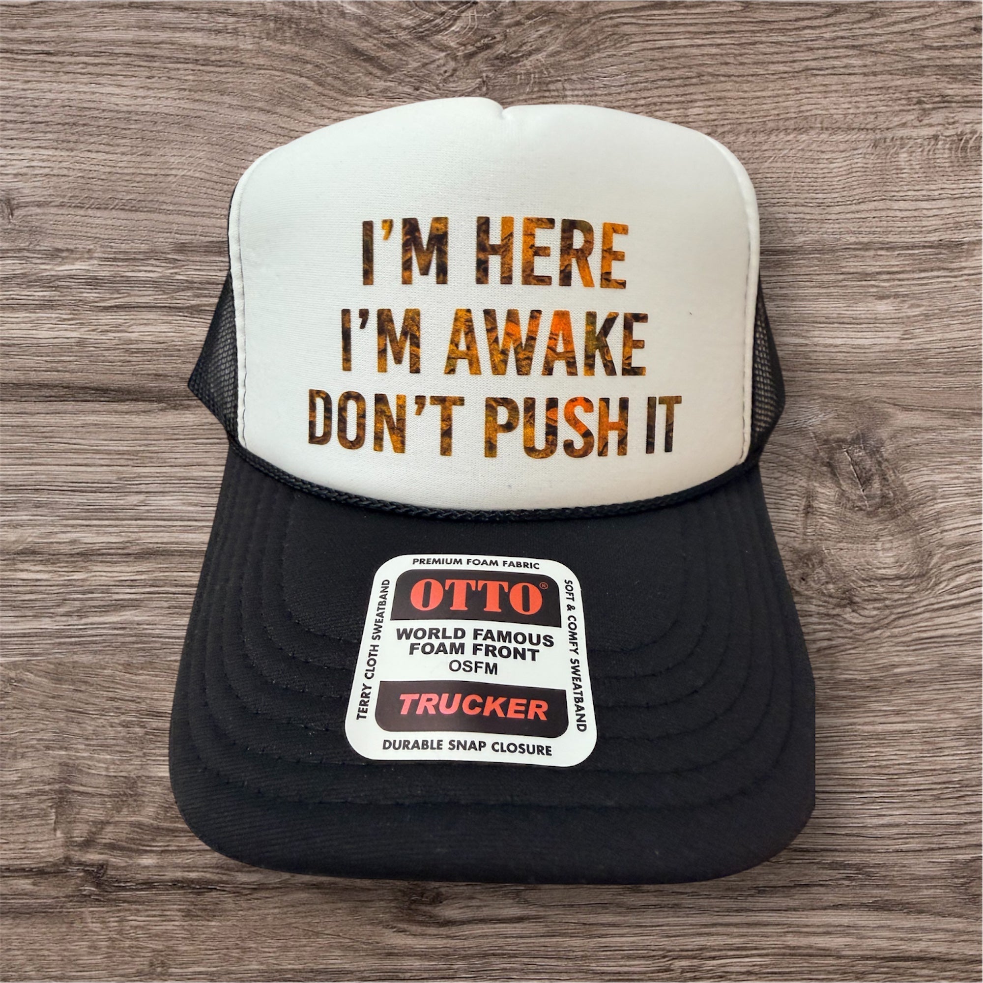 CAMO ORANGE WRITING IM HERE IM AWAKE- UNISEX BLACK AND WHITE Trucker Hat